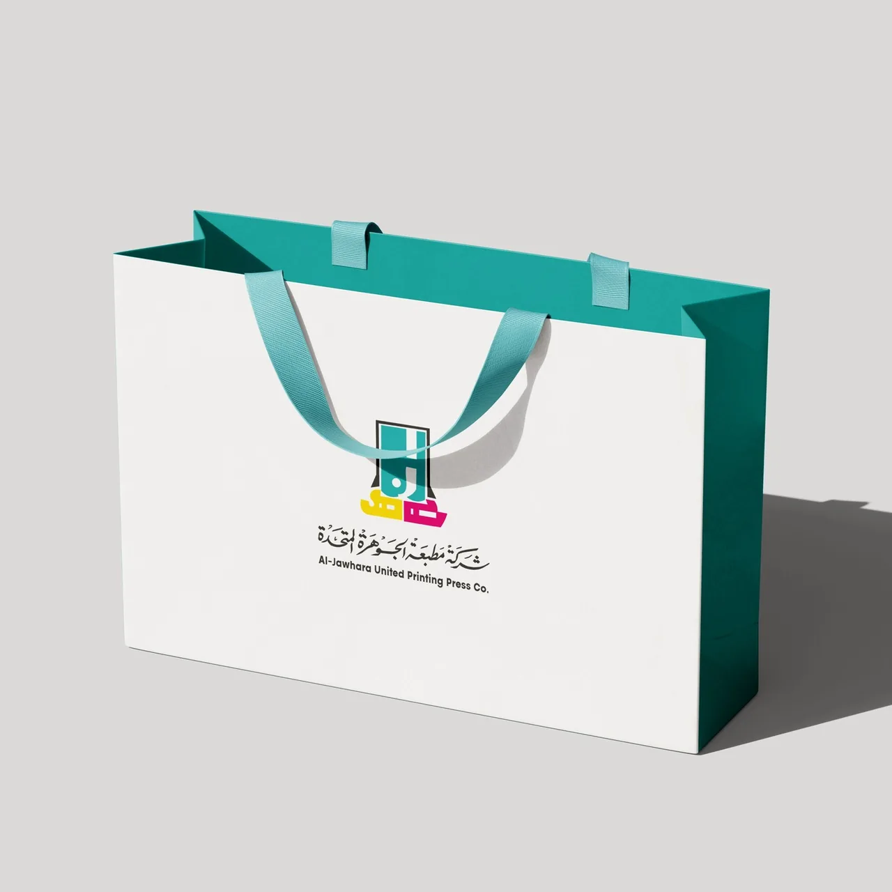 White shopping bag with teal ribbon handles