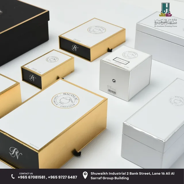 Collection of white rigid boxes with gold edges and drawer openings
